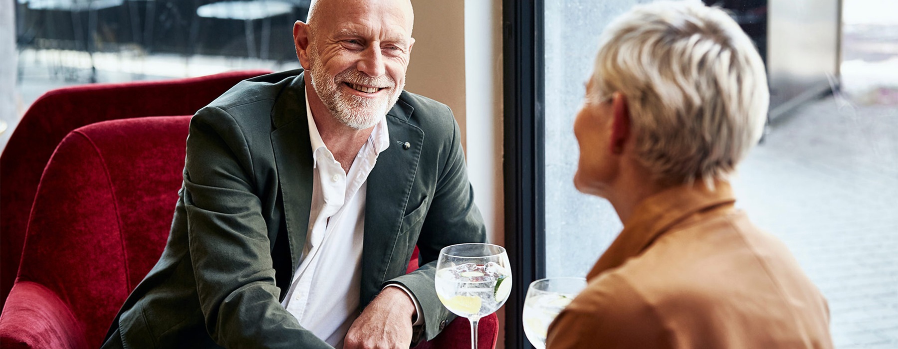55+ couple enjoying a glass of wine